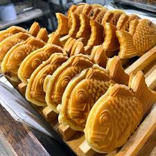 Fresh taiyaki cooling on a wooden rack