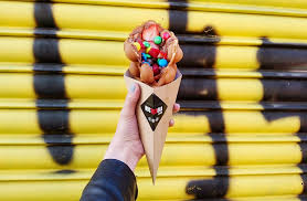 Bubble waffle cone with strawberries and candy toppings