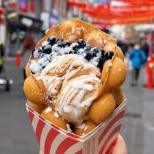Bubble waffle with ice cream, boba pearls, and white drizzle