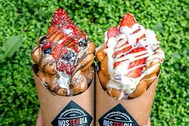 Two loaded bubble waffles in paper cones