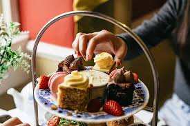 Afternoon tea stand with small cakes and macarons