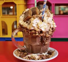 Chocolate freakshake with whipped cream and striped straws